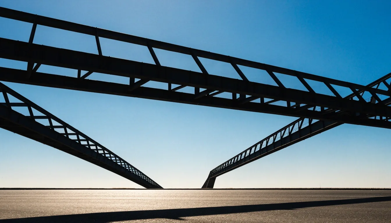 Highway gantry silhouette against a bright midday sky above dark asphalt